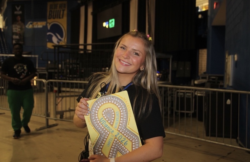 Mackenzie Wilson, a survivor of childhood cancer and member of the UDance executive board, posed for a photo just before welcoming guests to Sunday’s dance marathon.