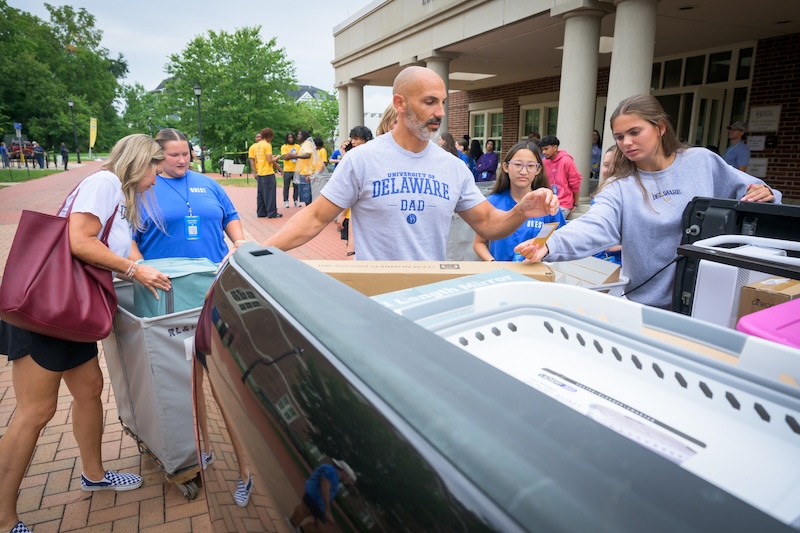 A UD dad unloads a car during move-in as first-year students and their families arrive on campus on Saturday, Aug. 22.