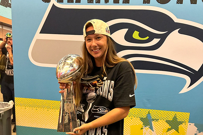 UD alumna Jennifer Witt, a seasonal athletic training intern for the Seattle Seahawks, holds the Lombardi Trophy after the Seahawks won Super Bowl LX.