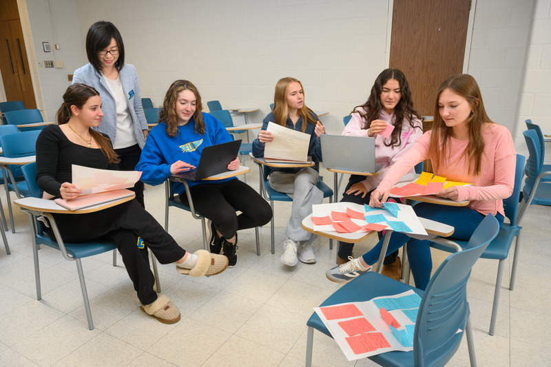 Associate Professor of Nursing Xiaopeng Ji, a College of Health Sciences Design Thinking and Innovation Ambassador, works with a second group of first-year nursing students on their idea to create an emotional companionship program, where nursing students could volunteer at local hospitals to help patients in hospice. 