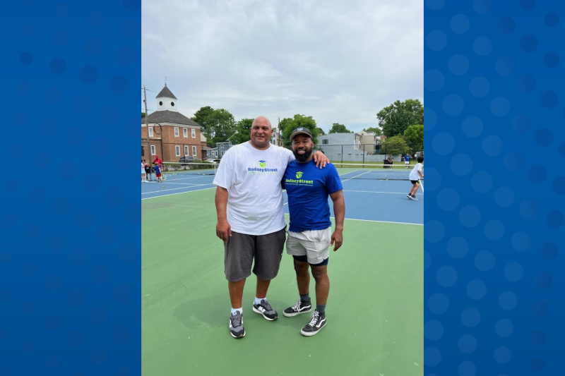 "Disengaged young people become disengaged adults. Young people want to be engaged and involved, but it's up to us to meet them where they are,” says New Castle Councilmember Brian Mattaway. (From left to right: Matt Johnson from Rodney Street Tennis and Mattaway poses for a photo at a free tennis clinic for children at Battery Park, a collaboration between the two organizations.)