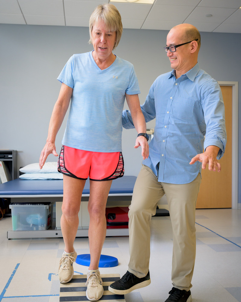 Daniel White, associate professor of physical therapy, guides Laura Schmitt through a balance and gait training exercise commonly used for patients with knee osteoarthritis. 