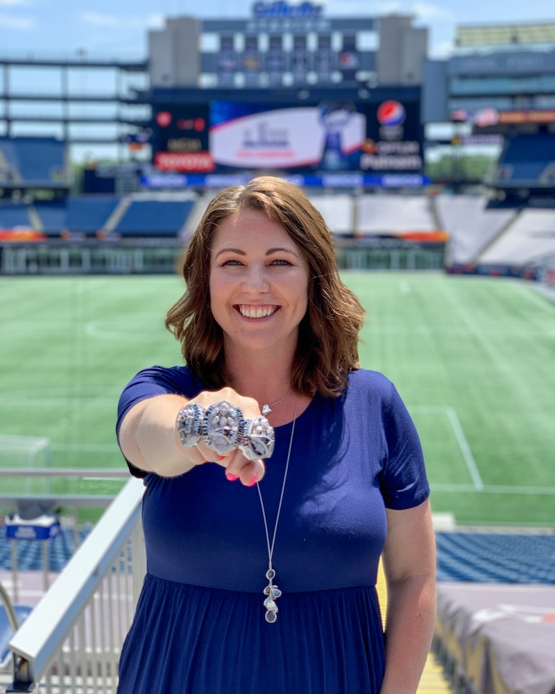 Abbey Thistle, senior director of event presentation and fan engagement, shows off her Super Bowl rings.