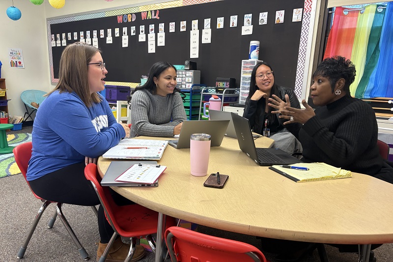 Mabel Boutte (right), principal at Etta J. Wilson Elementary School, talks with teachers Michelle Ramos, Bonnie Hernandez and Jessica Liu in a Wilson classroom. 