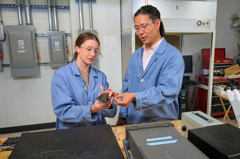 Charles Dhong, assistant professor of materials science and biomedical engineering, and postdoctoral researcher Abigail Nolin demonstrate a prototype tactile device designed to bring a sense of touch to digital screens. The technology aims to recreate physical sensations such as texture, opening possibilities for more immersive digital experiences and new accessibility tools. 