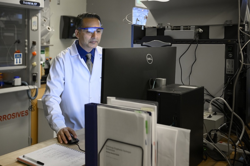Deb Jaisi carefully scrutinizes data on a computer that shows the isotope makeup of a family of phosphate molecules in the Orbitrap isotope ratio mass spectrometer. 