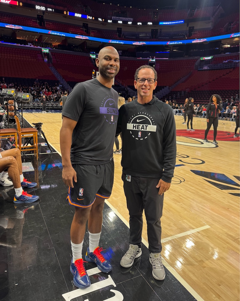 Orlando has worked as a team attendant for the Miami Heat. He is pictured with Phoenix Suns Assistant Coach Chaisson Allen, whom Orland met during his time at Northeastern University.
