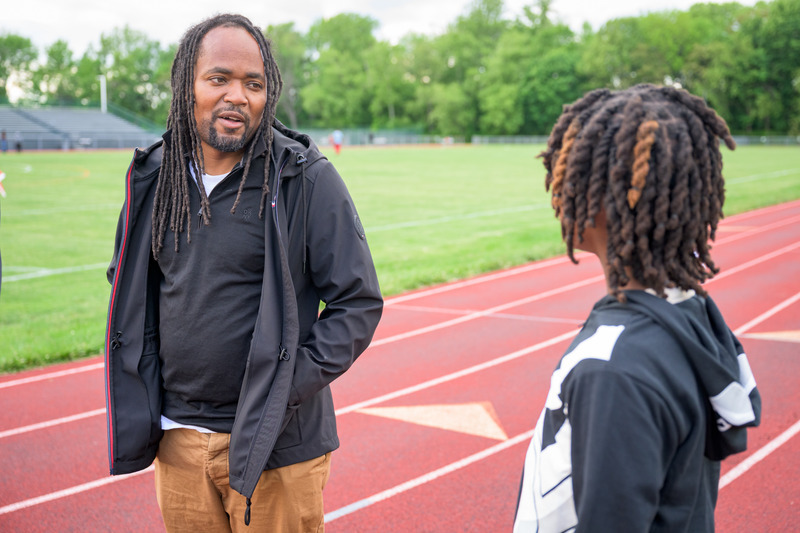 Antwain Flowers talks with an athlete during track practice