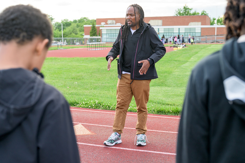 Antwain Flowers talks with athletes during track practice