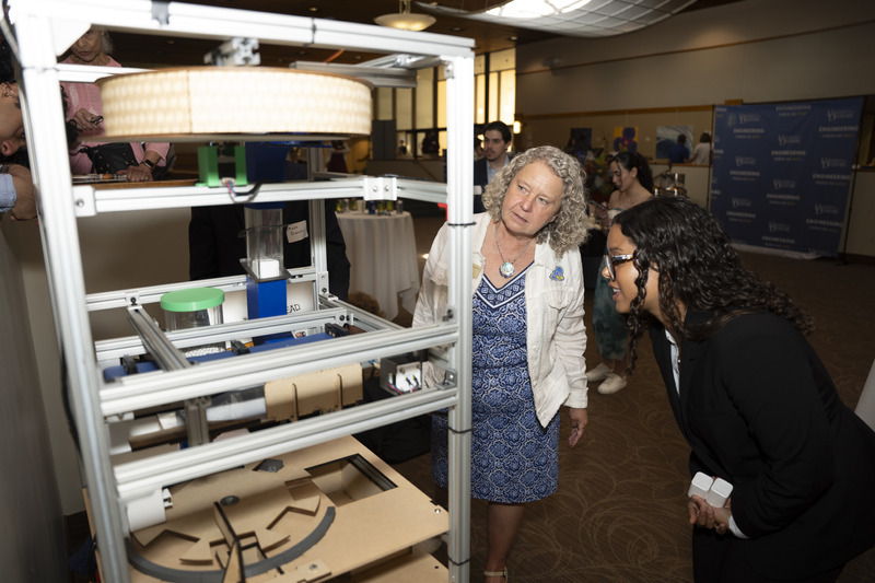 College of Engineering Dean Pamela M. Norris stopped to learn about a student-designed automated pill bottle-filling system during the college’s May 18 Research & Innovation Showcase.