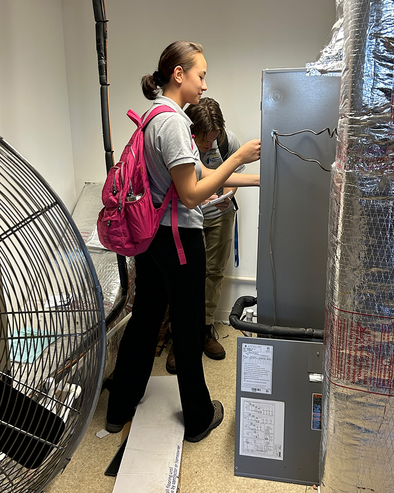 Eva Grise and Rocco Dumnich inspect an industrial facility during an audit, learning to quickly evaluate unfamiliar systems and processes.