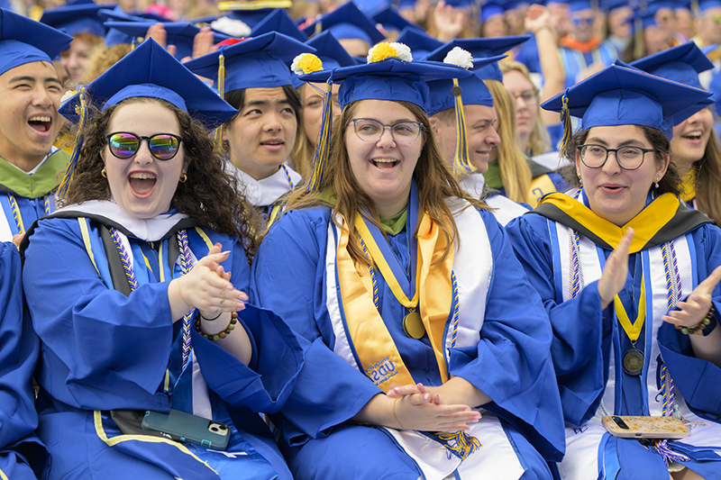 Eryn Cohen, Elena Lynn and Julia Diamond, honors graduates from the Class of 2025, celebrate at the 2025 University of Delaware Commencement at Delaware Stadium.