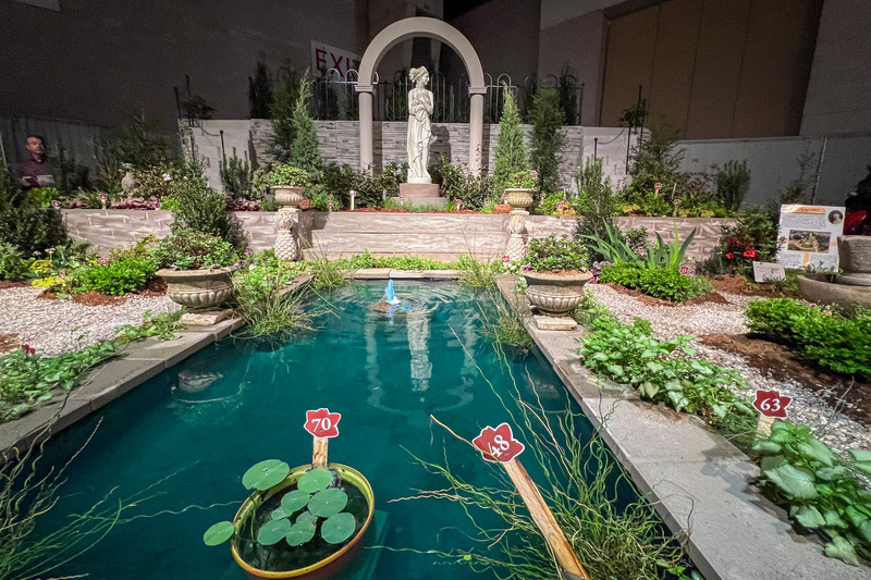 UD students put together a Philadelphia Flower Show exhibit spotlighting Marian Coffin’s influences. Notable parts of the exhibit include a reflecting pool with gardens on both sides of the pool to show symmetry, a concept Coffin used in a lot of her designs. The statue is a focal point, as Coffin often used statues in the gardens she designed. 