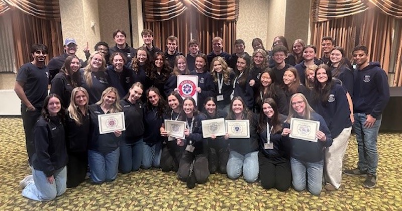 University of Delaware students who volunteer with the UD Emergency Care Unit (UDECU) accept the 2026 Collegiate EMS Organization of the Year award.