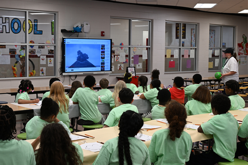 4-H afterschool participants at Mispillion Elementary School in Milford watch a video of a volcano erupting.