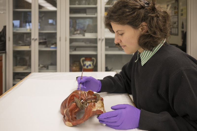 Third-year graduate fellow Daisy Diamond at work stabilizing and conserving objects in the conservation labs of Winterthur Museum, Garden and Library.