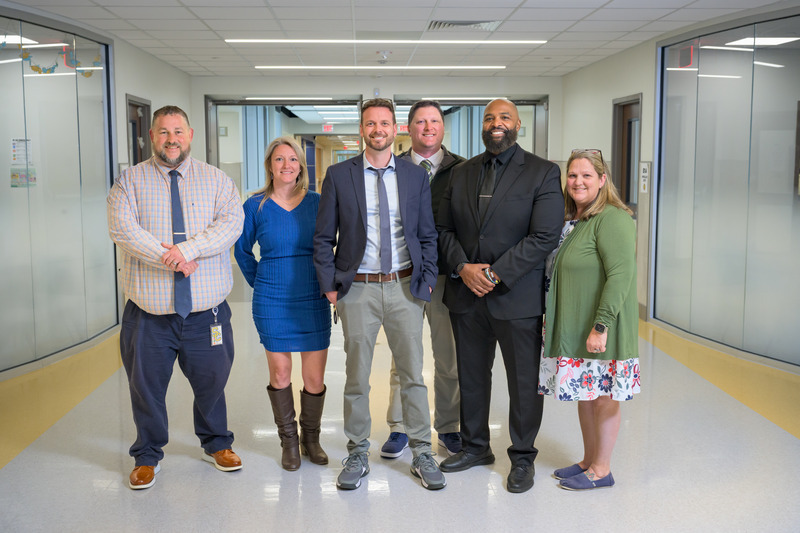 Wheatley (center) with colleagues at the high school. Wheatley (center) with colleagues at the high school.