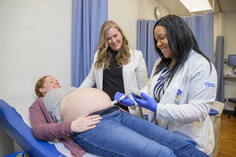 UD’s new nurse-midwife master’s program, launching this fall, serves a critical workforce need and is in direct response to healthcare shortages in the state. Pictured here, Amanda Watson, assistant professor of nursing and director of the nurse-midwife program (left), and Doctor of Nursing Practice student Briana Abernathy (right) provide labor support for Jennifer Eldred, undergraduate clinical coordinator for the School of Nursing. 