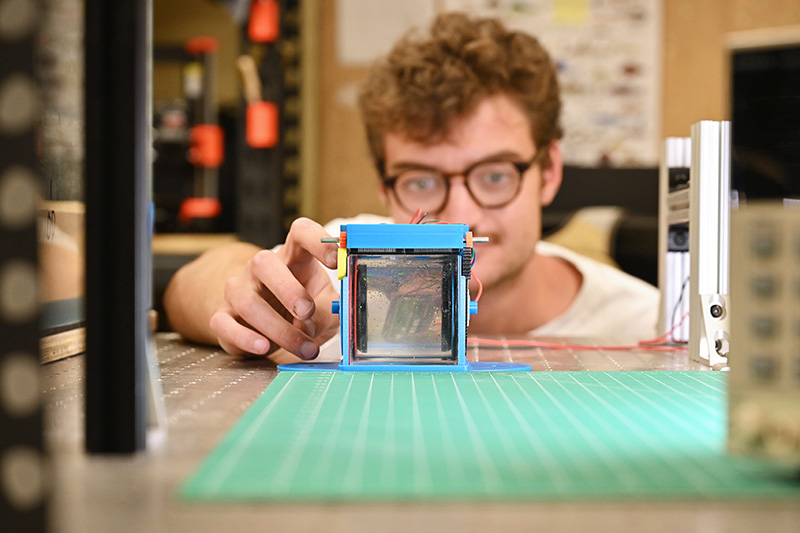 Graduate student Sam Meyer assembles and tests the Earth-based benchtop flow facility that the researchers will use for comparison to the International Space Station data.
