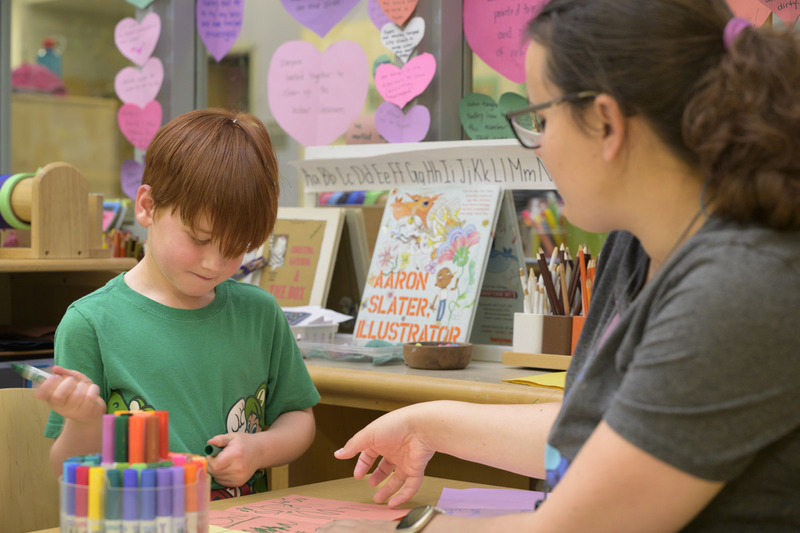 A UD education student guides a child in a writing activity at UD’s Lab School, an early education center for children from the ages of six months through kindergarten.