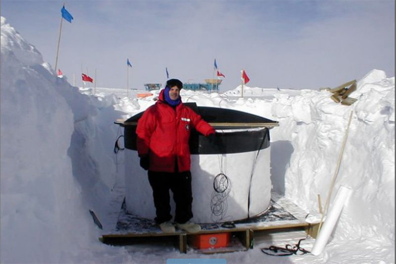 Gerald Poirier of the University of Delaware was among those who laid the groundwork for UD's participation in the IceCube Neutrino Observatory. In this photo, taken in December 2000, he is preparing 1,000 liters of ice with a detector in the ground as part of a "proof of concept" engineering effort. IceCube was in its infancy. In the background you can see flags marking proposed locations of the IceCube detector strings. The science building is in the background.