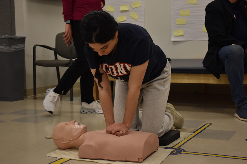 Doctor of Physical Therapy student Abigail Youmans participates in the 24-hour cardiac compression challenge. She's pictured here in a black shirt delivering chest compressions on a dummy. 