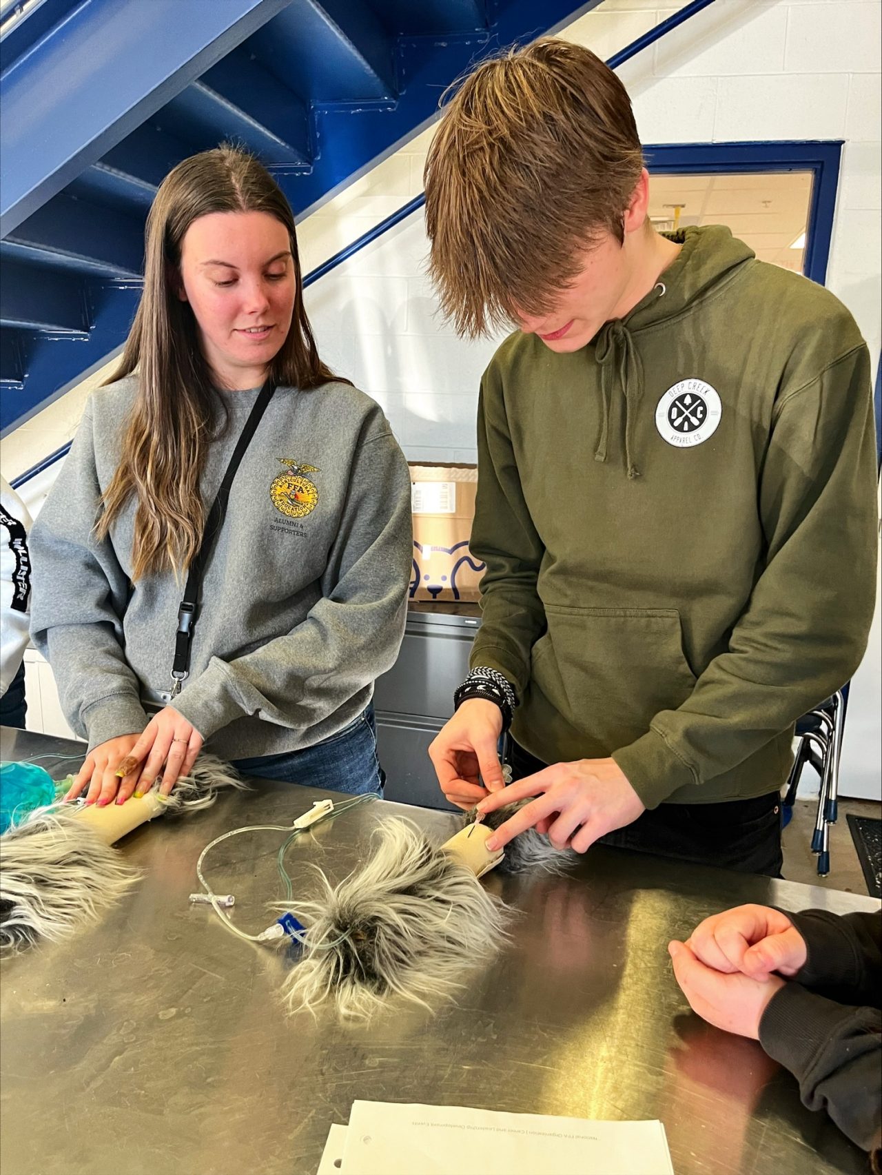 Emily Samick instructs a high school student. Samick earned both a B.S. in animal science and an M.S. in STEM education in just five years through UD’s 4 + 1 accelerated degree program. 