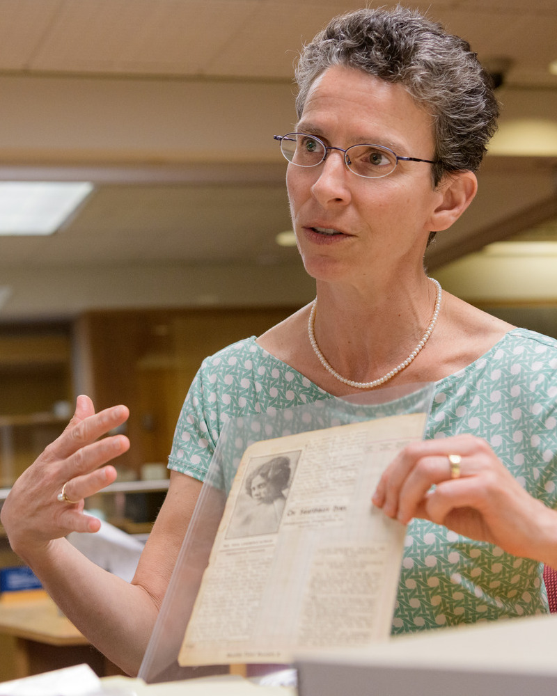 Alison Parker, UD’s Richards Professor of American History, holding and discussing an Alice Dunbar Nelson article owned by Special Collections. 