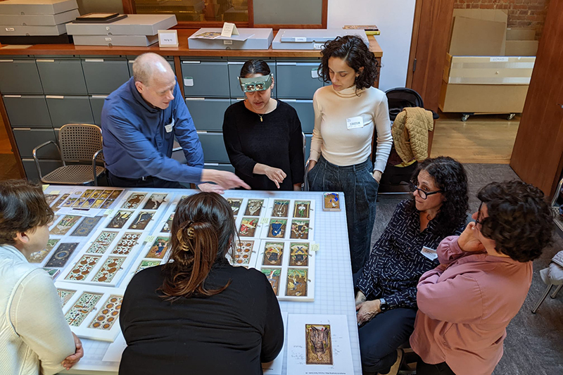 Members of the “Tarokee” examine cards. 