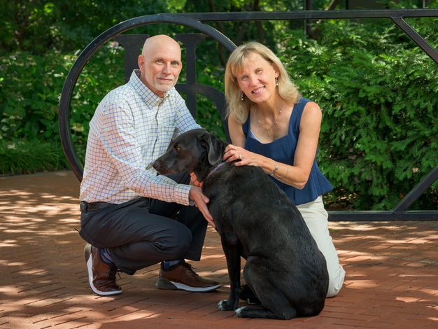President Laura Carlson with husband Robert West and their dog ”Bean”.