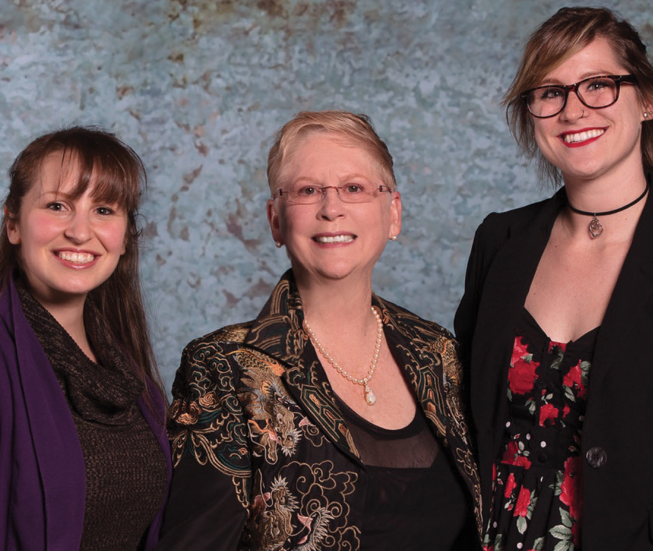 Photo of Dr. Julie Mapes Wilgen (center) standing with students
