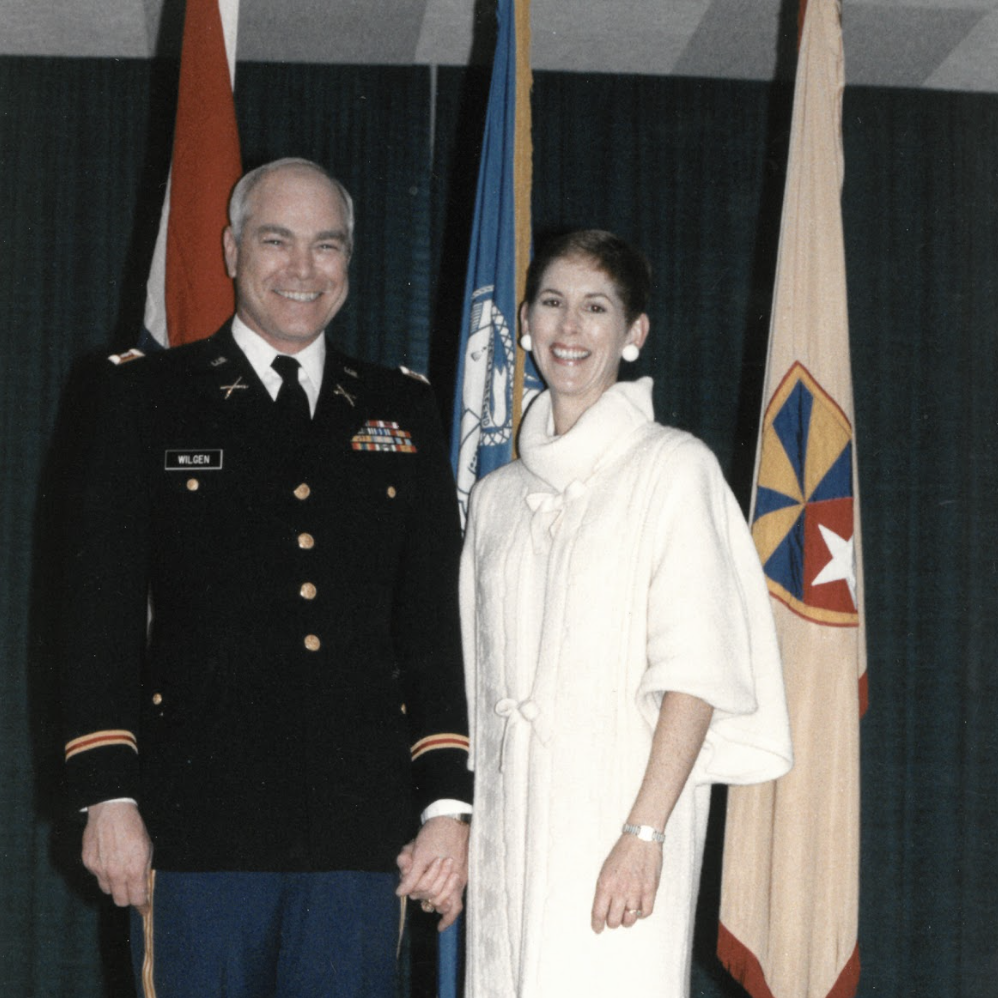 Photo of Lt. Col. Michael C. Wilgin and Dr. Julie Mapes Wilgen standing and smiling while wearing formal attire at a military-sponsored event