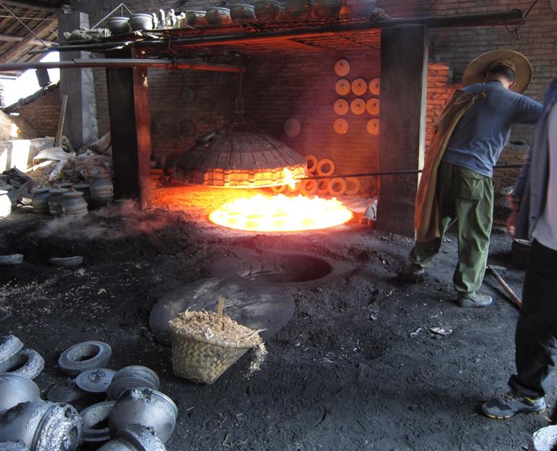 Photo of an artisan firing pottery in Sichuan, China