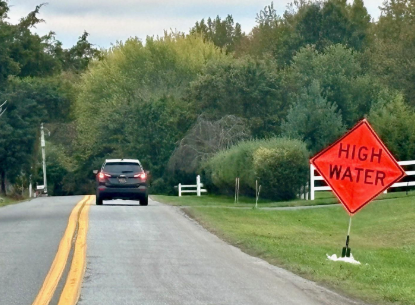 Figure 1. A sign warning drivers that the Blackbird Creek may flood the road ahead following the October 2025 nor’easter. Photo by Jennifer Volk
