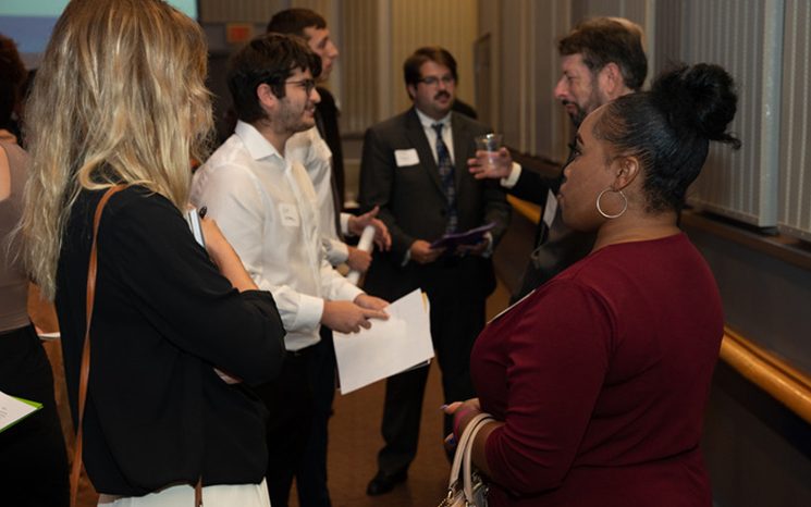 Group of students in professional attire networking