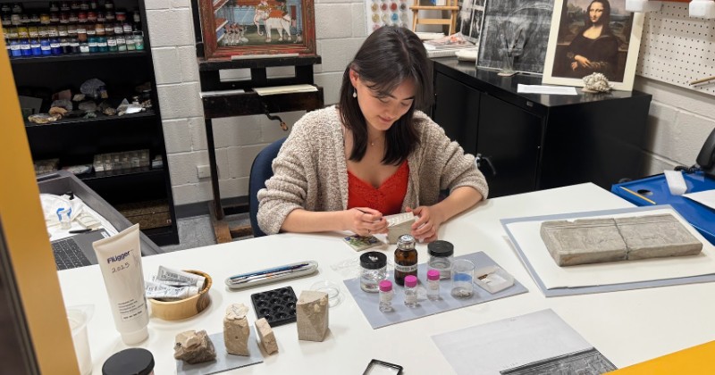 Student working on art artifacts