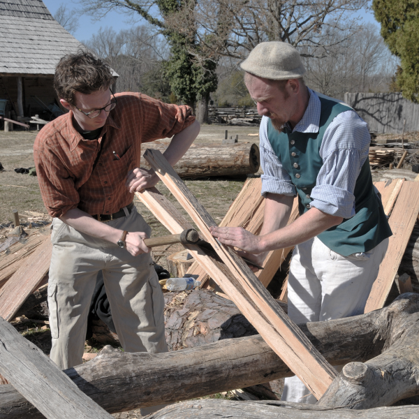 2 men chopping wood