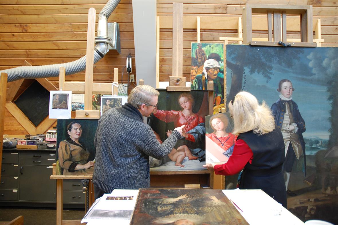 Paintings conservators Matt Cushman and Dr. Joyce Hill Stoner compare a student reconstruction of a painting to the original in the Paintings Conservation Studio.
