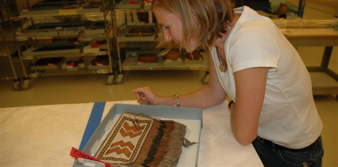 Christina Cole reviewing samples of Eastern Woodlands quillwork