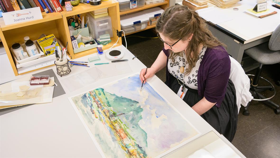 Joanna Hurd fixing a water color painting