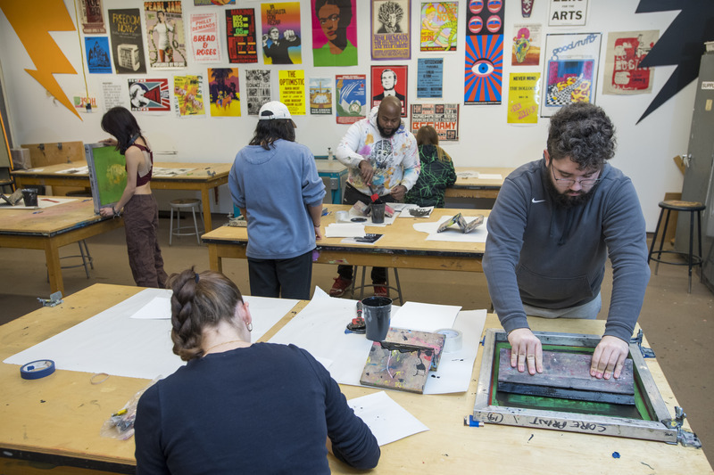 Students work on printmaking in Professor Amir Campbell’s (tie-dyed sweatshirt) ART 243 class - one of the many classes offered during Winter session.