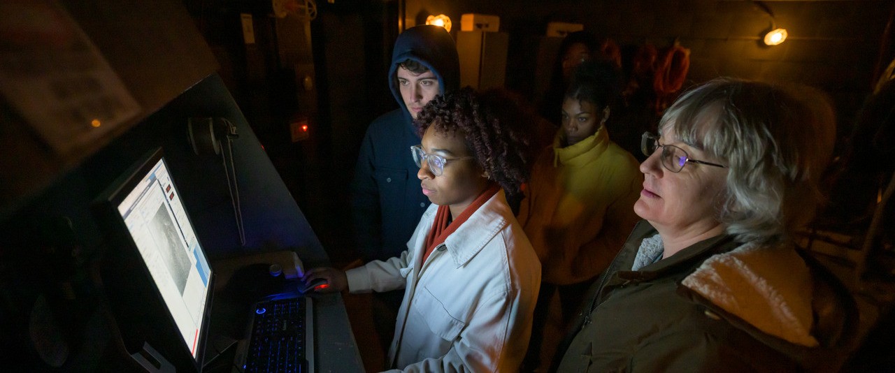Students in a space observatory with professor