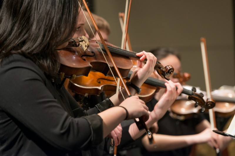 Students playing strings in orchestra