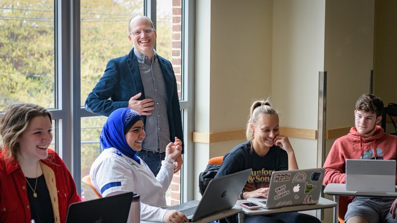 Prof. Jackson in discussion with students in class