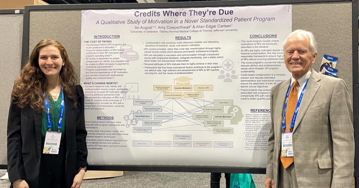 Woman and man standing in front of poster presentation