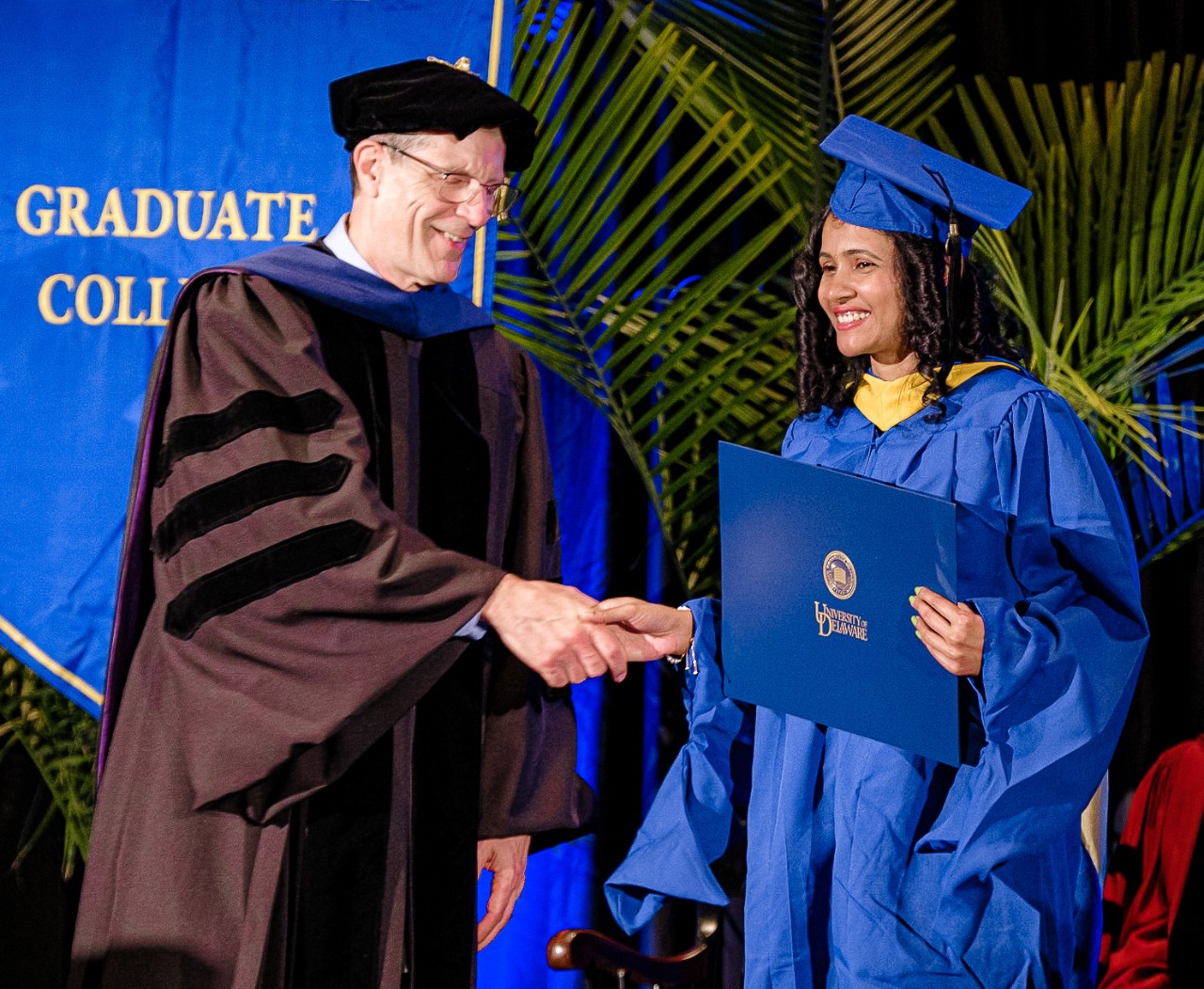 Rich Braun congratulating graduate