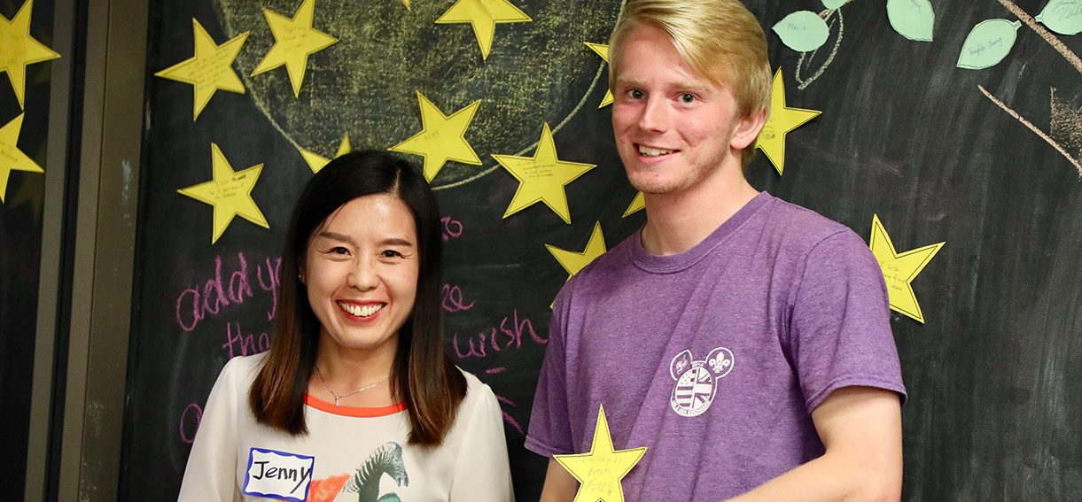 A student stands with a member of the Confucius Institute staff holding a star for the Chinese Mid-Autumn Festival