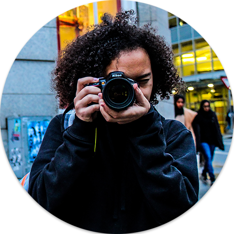 A photo of Morgan Kline-Hill taking a photograph.