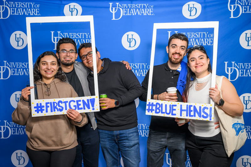 Group of students pose with first generation frames at the celebration