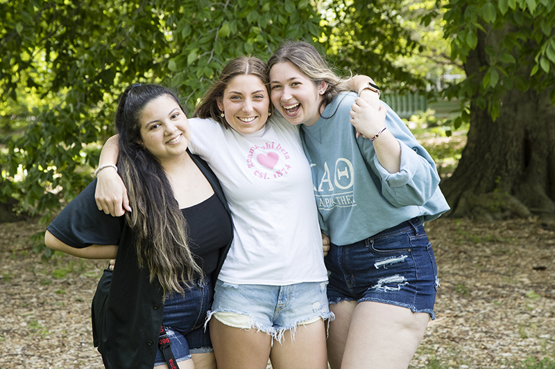 Three sorority members with arms around each other